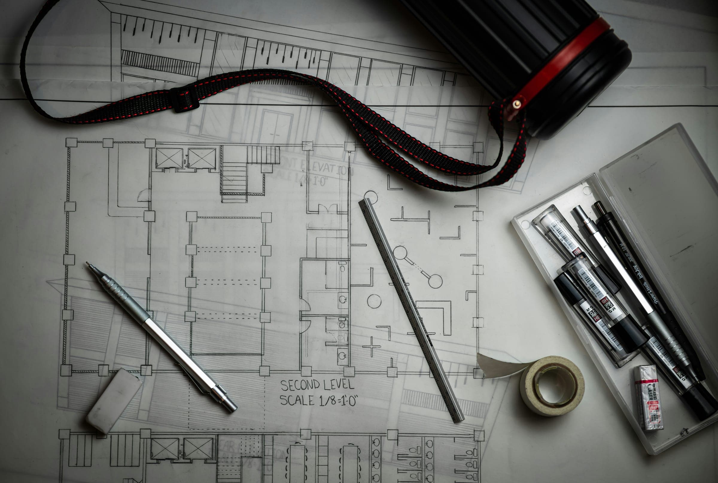 Architectural drawings with drafting pens and tools