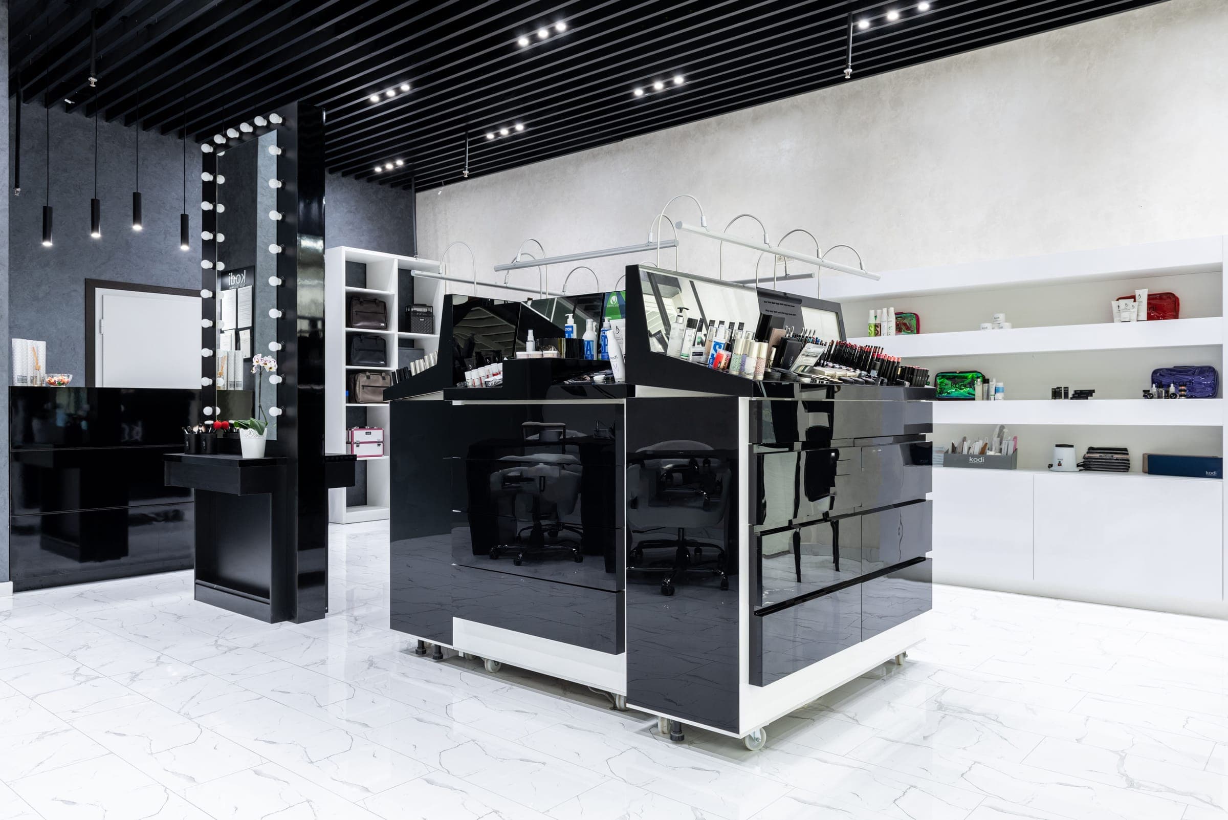 Black gloss freestanding display island in a white cosmetics store