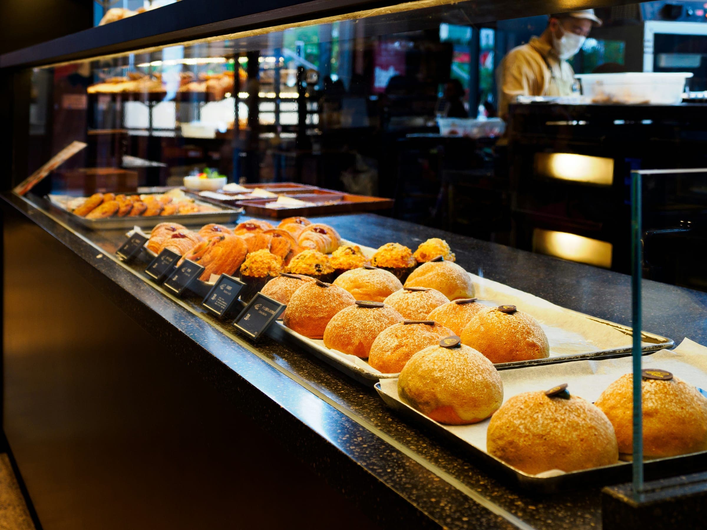 Bakery glass display case filled with pastries