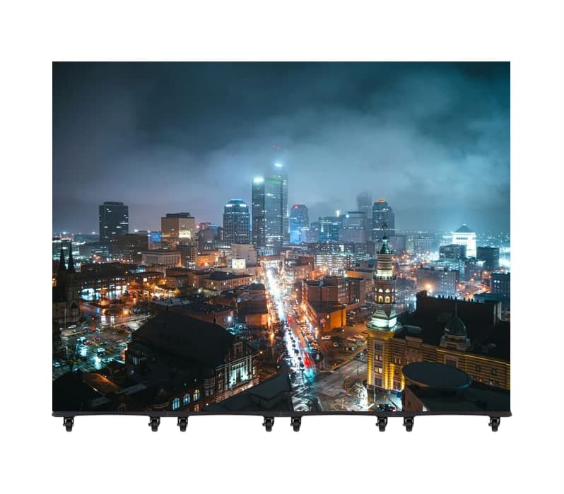 Mobile LED video wall on casters showing a city skyline