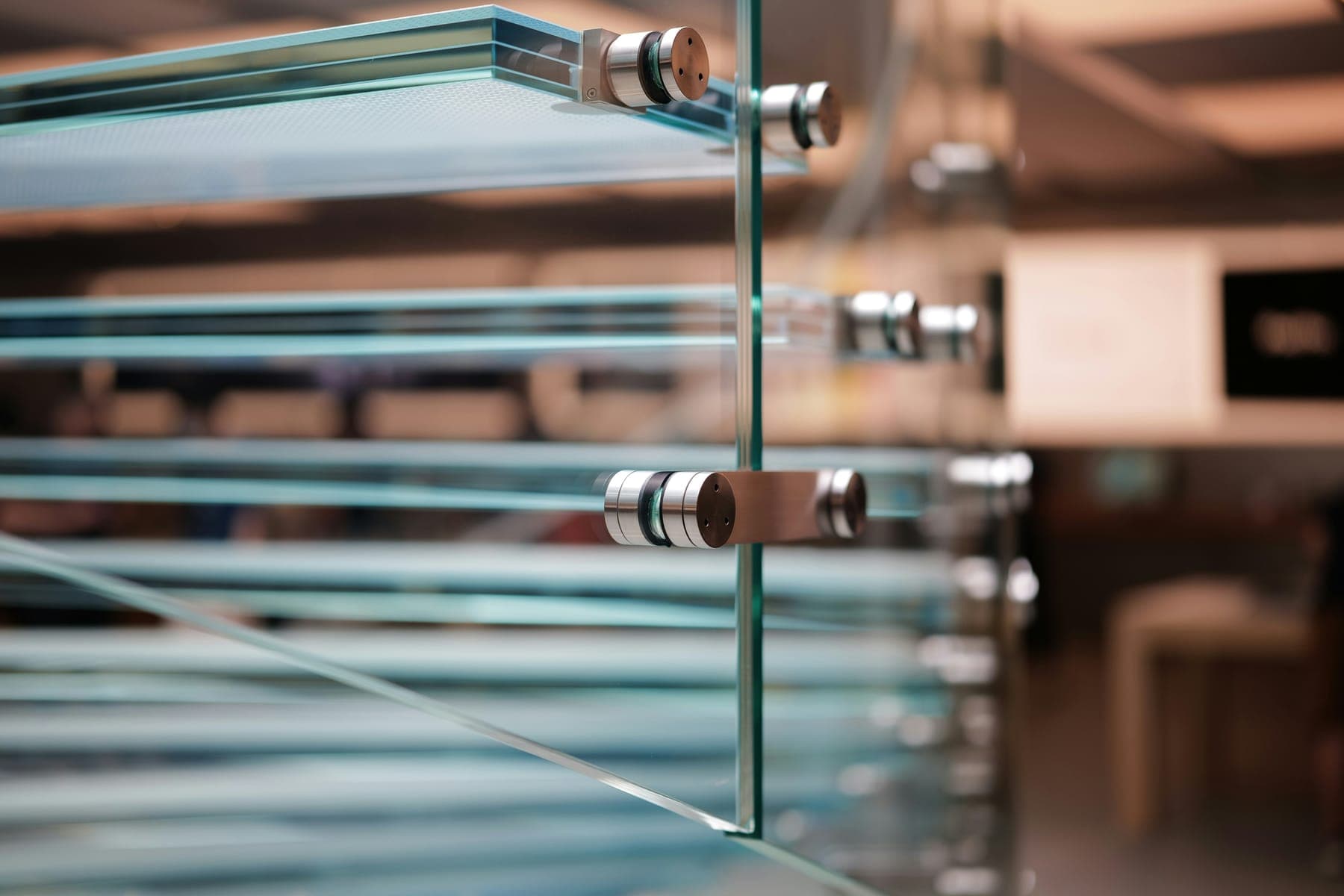 Stacked glass panels held by polished steel standoff fixings